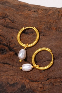 Detailed close-up of 18k gold plated hoop earrings with irregular white pearl pendants