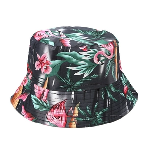 Detail of dark grey bucket hat with tropical flamingo print and palm leaf pattern