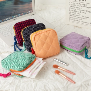 Quilted cotton cosmetic bags in various patterns with a green bag holding hygiene products