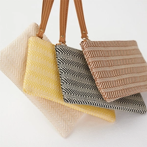 Woven straw wristlet bags with herringbone patterns in four stylish summer colors