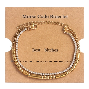 Detail of gold double-layer Morse code bracelet with rhinestones on a kraft display card