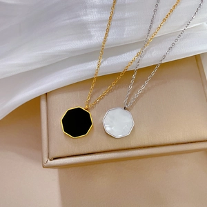 Macro view of gold and silver hexagonal shell necklaces on a jewelry box and silk
