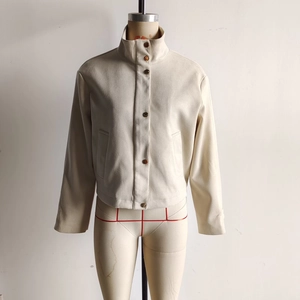 Detail of off-white faux suede jacket featuring vintage metal buttons and stand collar
