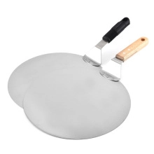 Detail of stainless steel pizza peels with ergonomic wood and black handles on white background