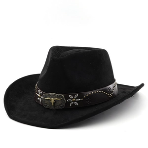 Detail of suede cowboy hat with leather band, metal studs and bull skull emblem