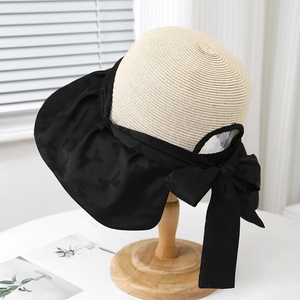 Women's foldable sun hat with straw crown, black wide brim and large bow decoration
