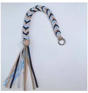 Detail of multicolored paracord weave handle with silver rings and decorative tassel
