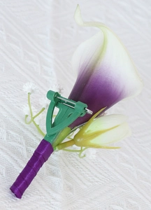 Detail view of purple Calla Lily corsage with ribbon-wrapped stem and pin fastener