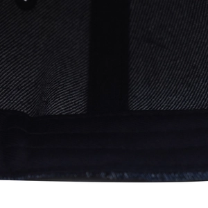 Detailed close-up of vintage washed black denim fabric with distressed texture and stitching