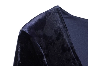 Detail shot of the V-neckline and rich navy blue velvet fabric texture on the dress