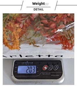 Detailed weight display of an orange autumn artificial plant wreath showing 203 grams