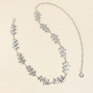 Detailed view of silver wavy link metal waist chain with adjustable lobster clasp