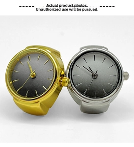 Detail view of gold and silver ring watches with gradient grey dials and adjustable crowns