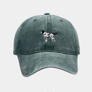 Close-up of realistic dog embroidery and washed dark green cotton fabric on baseball cap