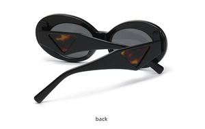 Rear view of oval cat-eye sunglasses featuring thick black frames and tortoise triangle accents