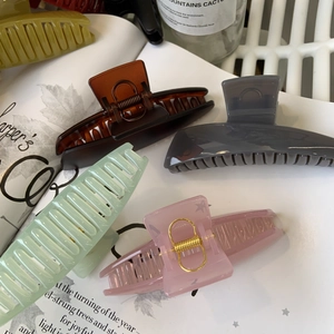 Close-up of matte Morandi resin hair claws on artistic book showing premium texture
