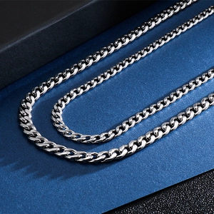 Macro shot of silver stainless steel Cuban links in various thicknesses with high polish