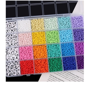 Detailed top view of 24-compartment storage box with assorted letter and seed beads