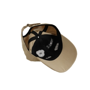 Inside view of beige kids baseball cap with bear pattern lining and adjustable strap