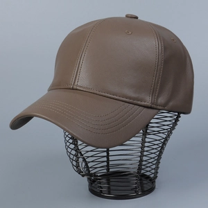 Detail shot of brown PU leather baseball cap featuring lychee grain texture and neat stitching