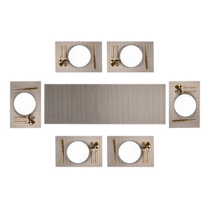Flat lay of gray woven PVC placemats and table runner set with elegant gold cutlery