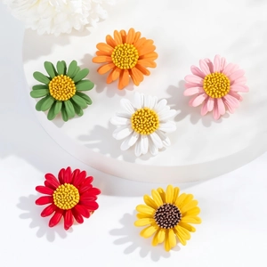 Detailed macro view of colorful enamel daisy brooches in six matte finish shades