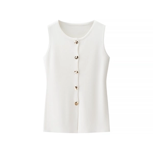 Close-up of white sleeveless knit vest with elegant gold textured metal buttons and ribbing