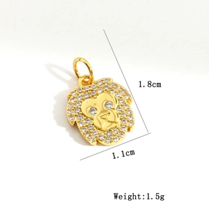 Detail of a golden monkey pendant with white zircon inlays and precise dimensions