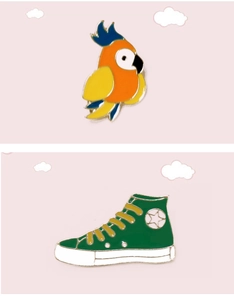Detail of colorful parrot and green canvas sneaker enamel pins on a pink cloud background