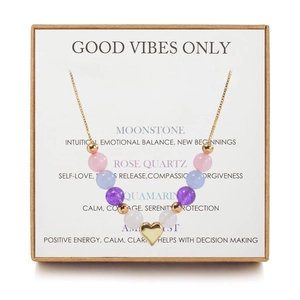 Detail of natural stone bead necklace with gold heart pendant in a premium gift box