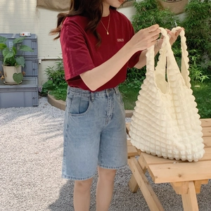 Outdoor shot showing the detailed white bubble texture of this spacious tote handbag
