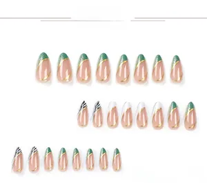 Detail view of almond-shaped press-on nails with green glitter and zebra patterns