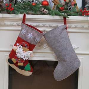Large Christmas stocking set with Santa applique and grey felt on a festive fireplace mantel