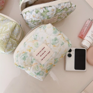 Close-up of quilted floral makeup bags showing cotton texture and zipper details