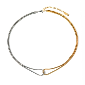 Flat lay of minimalist 18k gold and silver two-tone knotted snake chain necklace