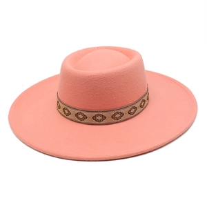 Detail view of coral pink wool fedora hat featuring ethnic geometric embroidery band