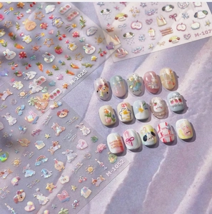 Close-up of rabbit and rainbow graffiti style nail art stickers with 3D floral designs