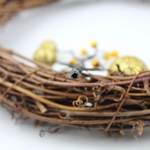 Macro shot showing natural vine texture and gold berry details on a Christmas wreath