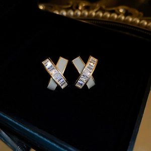 Detailed view of gold-plated cross geometric stud earrings with enamel and zircon