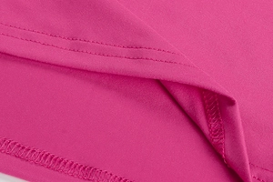 Detailed close-up of rose red knit dress showing high-quality hem double-needle stitching