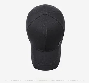 Top down view of black baseball cap showing metal letter logo and reinforced stitching