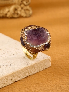Macro shot of irregular natural amethyst and pavé crystals on a vintage gold-tone ring