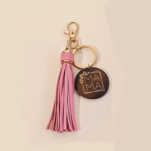 Macro shot of MAMA wood charm with pink PU leather tassel and golden key ring