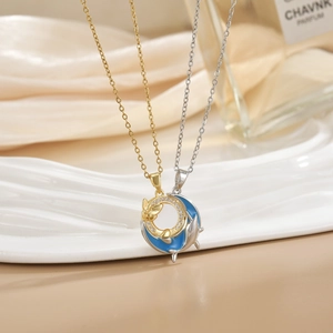 Detail of gold and silver dolphin necklaces with micro-pave crystals and blue enamel