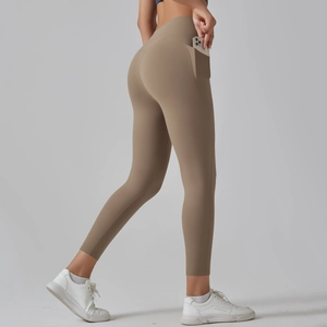 Detail view of high waist yoga pants with a side pocket showing phone storage