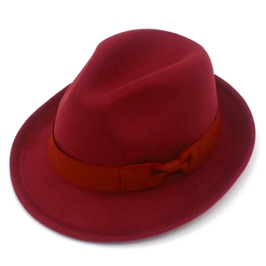 Detailed view of deep red wool felt fedora hat with matching ribbon bow accent