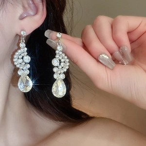 Silver drop earrings with sparkling teardrop crystals and round diamonds set for gowns