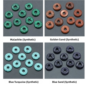 Macro detail of malachite, goldstone, turquoise, and blue sand stone ring pendants