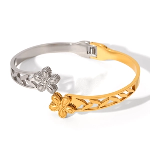 Two-tone gold and silver open bangle featuring floral engravings and vine hollow design