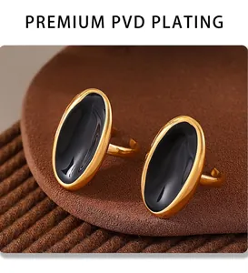 Macro shot of oval gold PVD plated stainless steel earrings with black enamel inlay